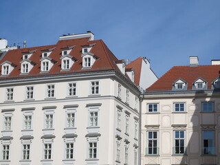 Fototapeta premium Vienna Historic White Buildings with Red Roofs and Blue Sky, Austria