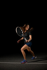 Fototapeta na wymiar athletic woman player with tennis racket at tennis court.