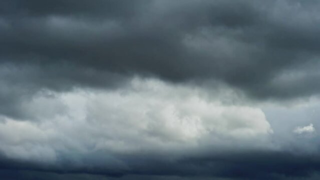 Footage with dramatic sky and dark grey fast moving storm clouds. Stormy cloudy rainy weather timelapse. Nature overcast