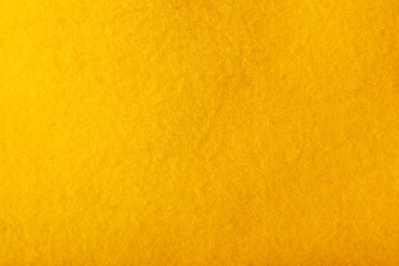 Autumn concept - plush yellow background. Knitted fabric texture, fleece fabric, inside of hoodie.