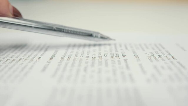 Close-up: woman lawyer office worker proofreading a contract before signing