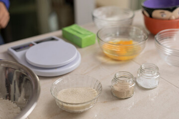 Scale and ingredients on a table to make bread at home