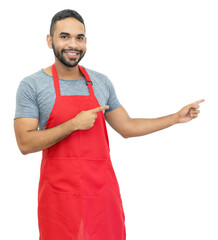 Latin american clerk or waiter or chef with red apron pointing sideways