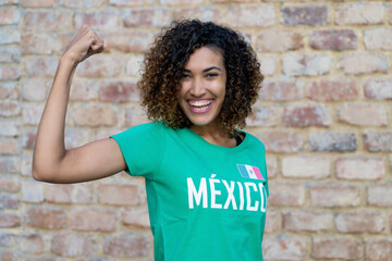 Naklejka na ściany i meble Optimistic mexican female football fan