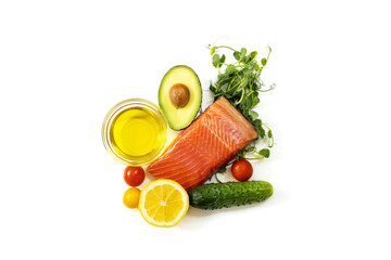 Ingredients of healthy food. Fish, micro green pea sprouts, olive oil, cucumber, tomato, avocado. Ketogenic low carbs diet concept.
