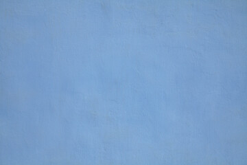 Blue or sapphirine wall, texture, background. The building wall, painted with water-based paint. Smooth (flat) surface in blue color with a little stains or dust. Bluish backdrop - obrazy, fototapety, plakaty