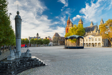 Maastricht, Netherlands 10-24-2022 An empty vrijthof square in downtown Maastricht with a dramatic cloudscape and the typical skyline withthe Servaas baslicia, red tower of Sint Jan and Perroen statue