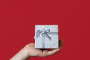 Gift box on a red background. Copy space. Holidays and events. Gift shop