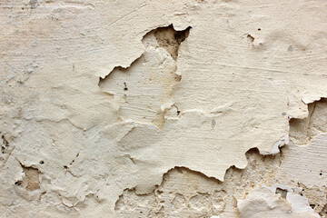 Old paint on the dirty cement wall background. Wall with shabby damaged plaster. Texture, pattern, background. Copy space.