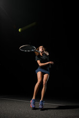 beautiful shot of healthy woman with tennis racket in her hand bouncing to hit the tennis ball.