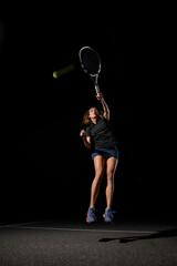 great view of athletic woman with tennis racket in her hand bouncing to hit the tennis ball.