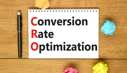 CRO conversion rate optimization symbol. Concept words CRO conversion rate optimization on white note on a beautiful wooden background. Business CRO conversion rate optimization concept. Copy space.