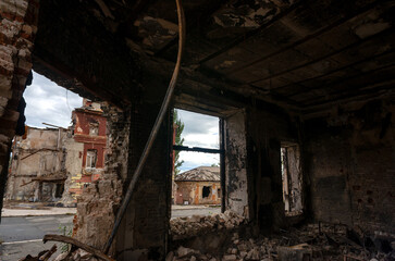 Plakat destroyed and burned houses in the city during the war in Ukraine.