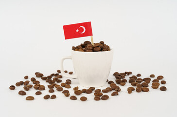 The Turkish flag sticks out of a cup of roasted coffee beans.