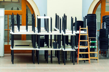 Tables and chairs are stacked on top of each other after the event