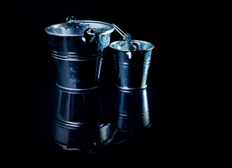 Many aluminum ice bucket laid in wait for use. many stainless multi-colored buckets © Anton
