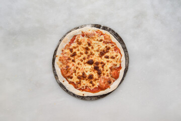 margherita pizza over a white stone