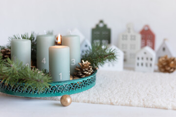 Fototapeta na wymiar Handmade modern advent wreath with four candles lit every sunday before christmas. Traditional diy xristmas decoration