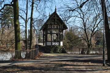 wooden pavilion by the pond image of a tree in Wrocław zoo, Poland