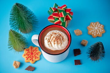 Winter Christmas holidays background with Cup of cocoa or hot chocolate with whipped cream with cinnamon sprinkles