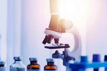 biochemical research scientist team working with microscope for coronavirus vaccine development in pharmaceutical research labolatory, selective focus