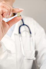 Healthcare and medication vertical banner with doctor holding pill.