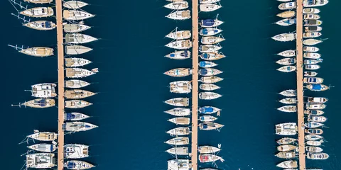 Fotobehang Aerial view of different boats in marina in Kas,  High angle view of  luxury yachts moored on sea harbor.  Sailboats docked in a row at port Antalya, Turkey. © tgordievskaya
