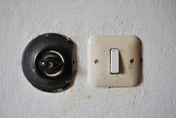 two vintage light switches on the wall