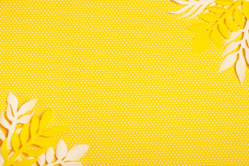 
yellow polka dot background with yellow and white paper flowers
