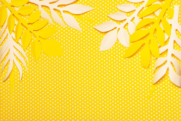 
yellow polka dot background with yellow and white paper flowers