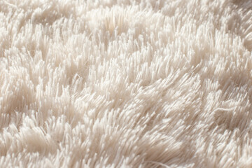 Texture of fluffy white artificial plaid, close up