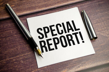 SPECIAL REPORT ext on a notepad with pen, business