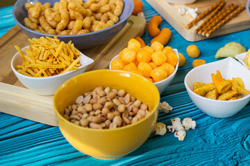 Beer salty snacks on wooden table