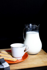 Rustic Breakfast with Milk, Coffee, and Biscuit on a Wooden Tray