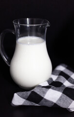 Glass Jug of Fresh Milk on a Dark Background - Minimalist Still Life