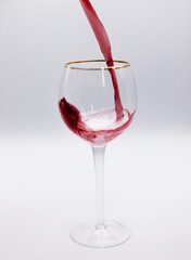 red wine pouring into glass