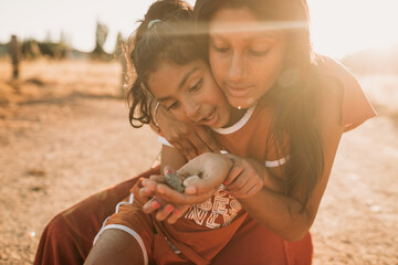 Older sister showing her younger sister rocks 
