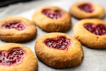 Homemade cookies decorated with raspberry jam in the shape of a heart