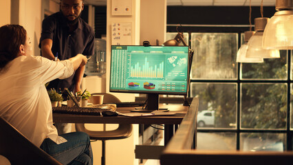 Employee working with landline phone and financial sales data, planning research presentation with company shares. Analyzing executive investment report on computer.