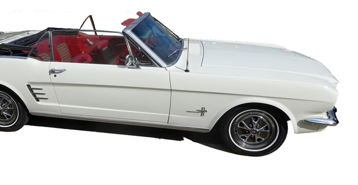 Isolated classic white convertible Ford Mustang with a red interior