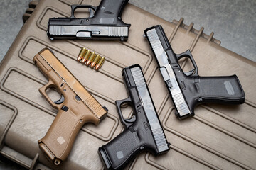 Weapons, many 9mm pistols close-up. - obrazy, fototapety, plakaty