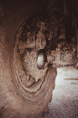 Off-road truck steering knuckle covered in mud