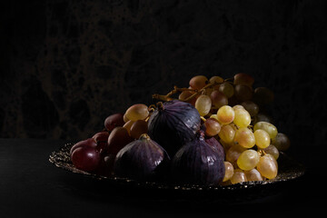 figs and grapes on a silver plate
