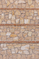 stone wall texture background separated by three rows of bricks