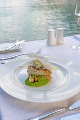 Fish served on a plate with pea puree