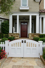 double gate leads to front entry of craftsman cottage
