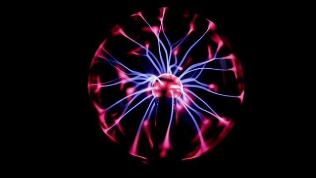 One ball night lamp with a red-lilac moving electric charge on a black background, side view, close-up in slow motion.