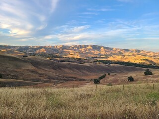 The evening sunlight shines on the hills of Northern California