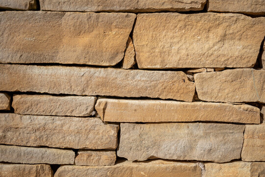 Pierre blanc / orang&eacute; artisanal d'un mur d'une fontaine