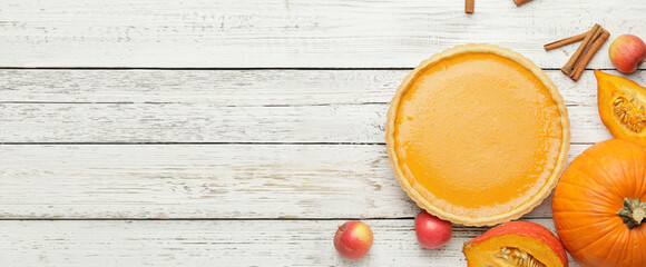 Composition with tasty pumpkin pie on wooden background with space for text, top view